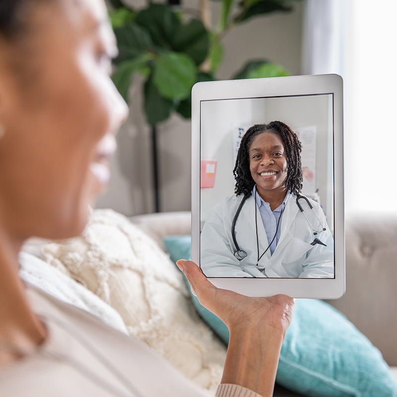 Mature woman discusses health issue with doctor during a telehealth appointment